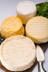 French AOC soft cow cheeses, crumbly Langres with washed rind structure, sharp Pie Angloys, camembert with strong taste and brie served as dessert after dinner