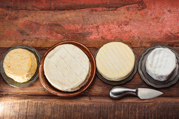 French AOC soft cow cheeses, crumbly Langres with washed rind structure, sharp Pie Angloys, camembert with strong taste and brie served as dessert after dinner