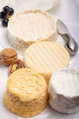 French AOC soft cow cheeses, crumbly Langres with washed rind structure, sharp Pie Angloys, camembert with strong taste and brie served as dessert after dinner