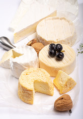 French AOC soft cow cheeses, crumbly Langres with washed rind structure, sharp Pie Angloys, camembert with strong taste and brie served as dessert after dinner