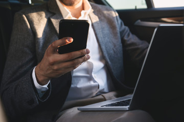 Close up of businessman holding mobile phone