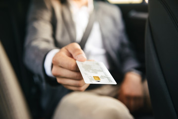 Close up businessman giving credit card to driver
