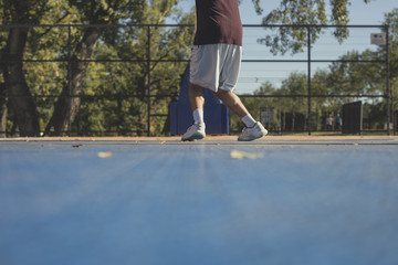A Men Shooting at Basketball Hoop