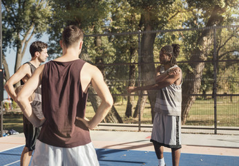 Basketball Players Stretching on the Court