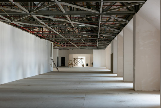 House Attic Under Construction. Interior Of  Large Unfinished Mansard.