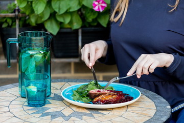 Duck breast with spinach leaves and berry sauce.