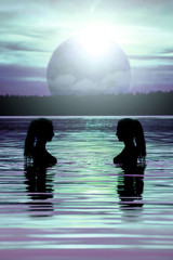 Fantastic view of nude silhouettes of sexy girls in the water against the  background of an amazing purple cosmic planet.