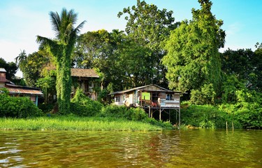 Houses at riverbank for local people in rural area. Common scene at fisherman villages. ​