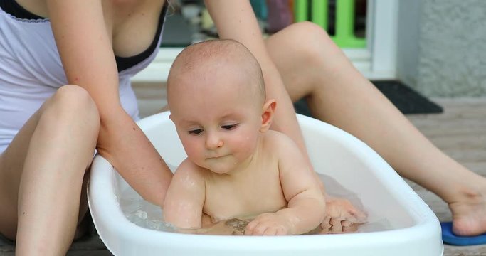 Baby Boy Playing In His Bathtub Outside, Cute Eight Month Old Baby Boy. Close Up View - DCi 4K Resolution
