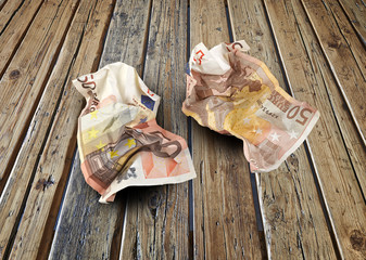 Euro bills on wooden textured table