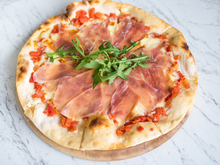 Traditional Italian fresh Prosciutto parma ham pizza.