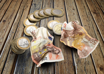 Euro coins and bills on wooden textured table