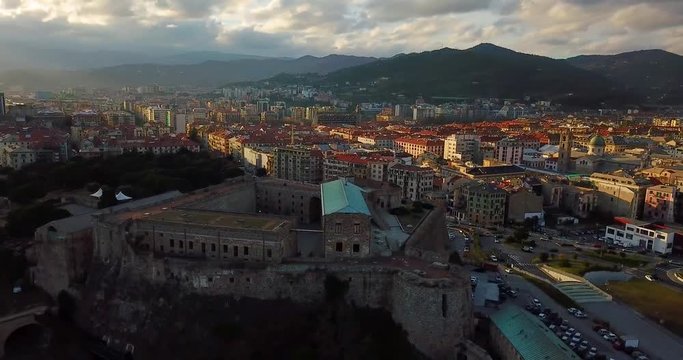 Fortress of Priamar in Savona Italy in a beautiful sunset and build and houses in background by drone