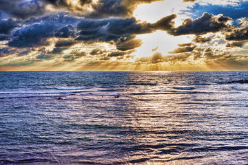 Tropical scenic sunset with the sunbeams hit the sea