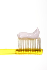 Close up of a toothbrush with toothpaste isolated on a white background with space for copy