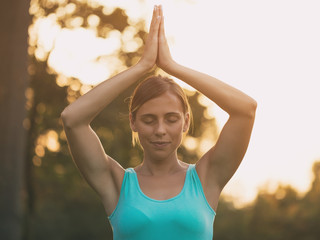 Beautiful  woman enjoys  meditating in the nature.