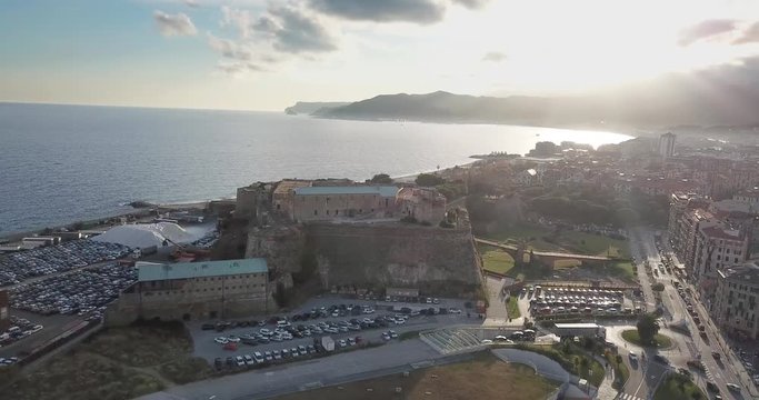 Fortress of Priamar in Savona Italy in a beautiful sunset and build and houses in background by drone