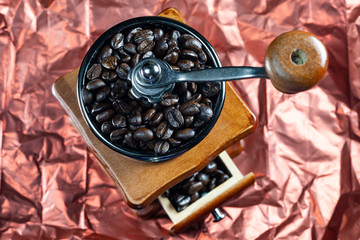Coffee beans and vintage wooden grinder.