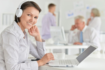 Fototapeta premium Portrait of a young woman with headache working