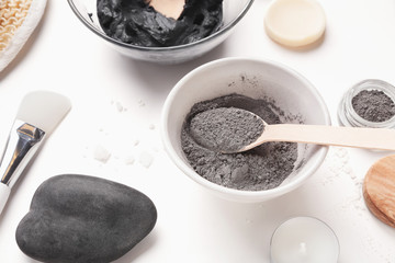 Facial mask and scrub on white background