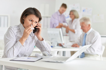 Fototapeta premium Portrait of a young woman with headache working