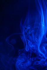 Blue smoke on black background.