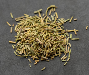 Dry rosemary spice on dark. Macro with shallow depth of field.