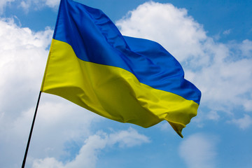 Flag of Ukraine against the blue sky. Horizontal shot.