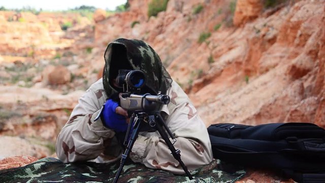 Slow Motion: Close-ups that snipers with guns to the mission on the mountain footage
