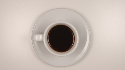 TOP VIEW: Dark coffee in a white coffee cup