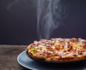 Hot Homemade Pepperoni Pizza on the plate with Steaming  Ready to Eat