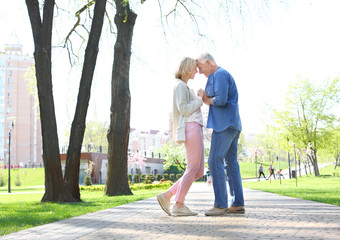 Mature couple resting in park on spring day