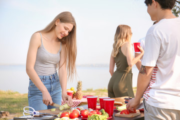 Young people having barbecue party on sunny day outdoors