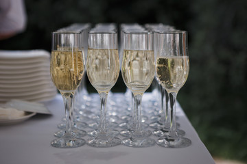 wedding ceremony outdoors, champagne glasses on the table