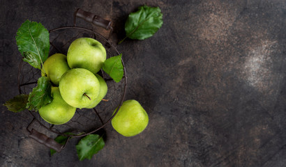 Top view of green apples on rusty background