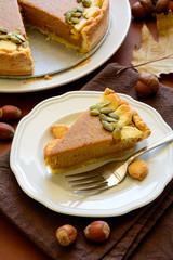 Homemade pumpkin pie with cinnamon on brown paper background. Thanksgiving day or Halloween holiday concept