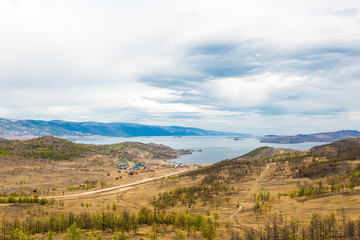 Fototapeta na wymiar View of the Maloe More Strait, Curkut Bay and tourist centers on the shore. September. Lake Baikal, Siberia, Russia.