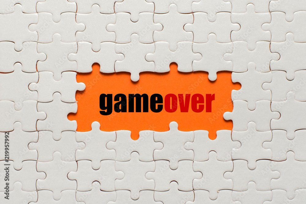 Fototapete white details of puzzle on orange background and text game over