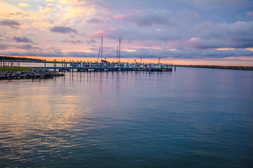 Fototapeta na wymiar Sailing Sunset Sky Background.. Michigan marina along the Great Lakes coast with a beautiful sunset sky. Cheboygan, Michigan. 
