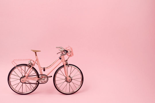 Pink vintage bicycle on pink background. pastel minimal style concept.