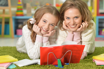 Portrait of a mother helps with homework