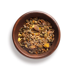 curry spice mix  in a wooden bowl, isolated on white