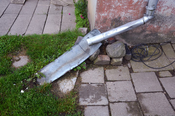 used rain gutter downspout near  flat house wall