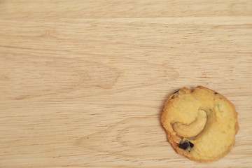 Almond and chocolate chip cookies on wooden plate.