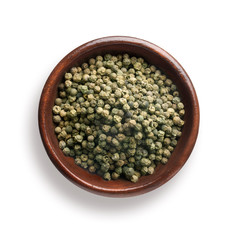 green pepper in a wooden bowl, isolated on white