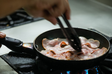 Bacon cooked in frying pan.