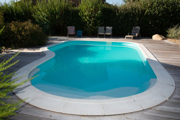 Oval swimming pool in a garden area beautiful park