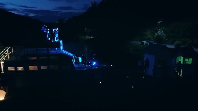 Aerial shot: Night action. A scene of recognition in love, a request of the hand and heart on the ship
