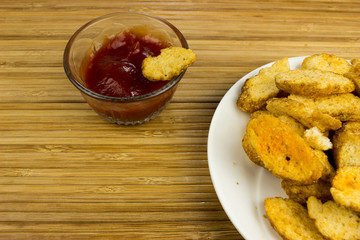 Snacks on a plate. Wooden table. Salty food for beer