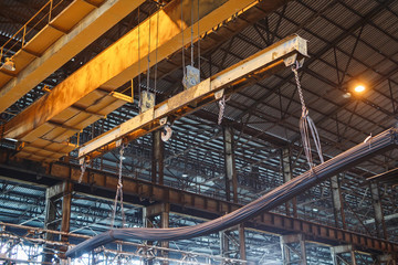 Crane loader carries rebar and wire rod in the factory.